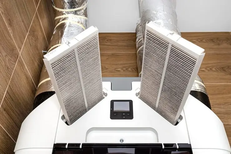 home-mechanical-ventilation-with-heat-recovery-hanging-wall-visible-dirty-filters-sticking-power-repair-team
