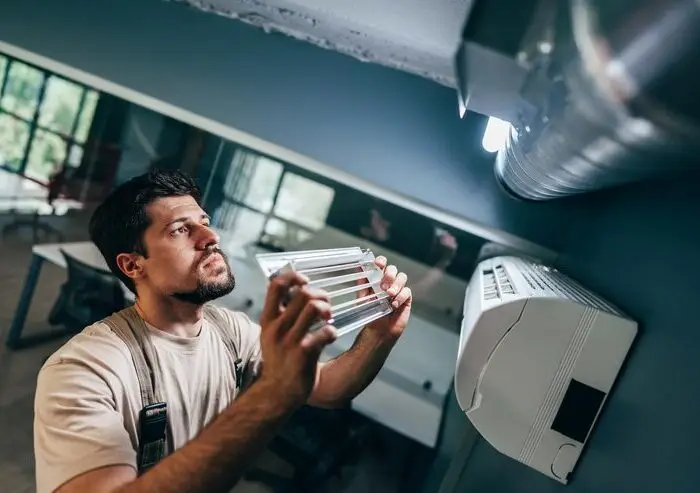 worker-installs-new-light-fixture-while-ensuring-proper-alignment-modern-office-space-power-repair-team